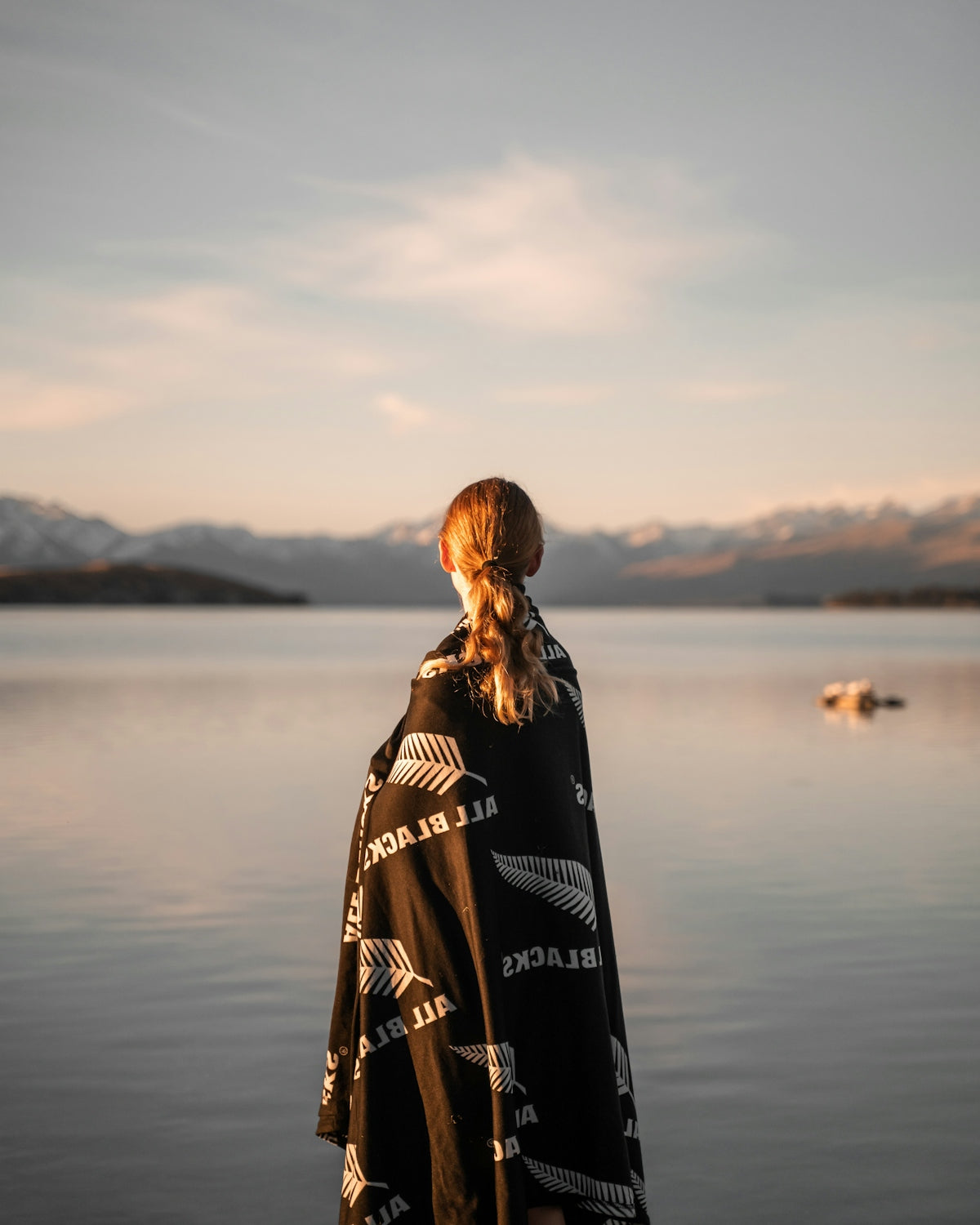 a person standing in front of a body of water