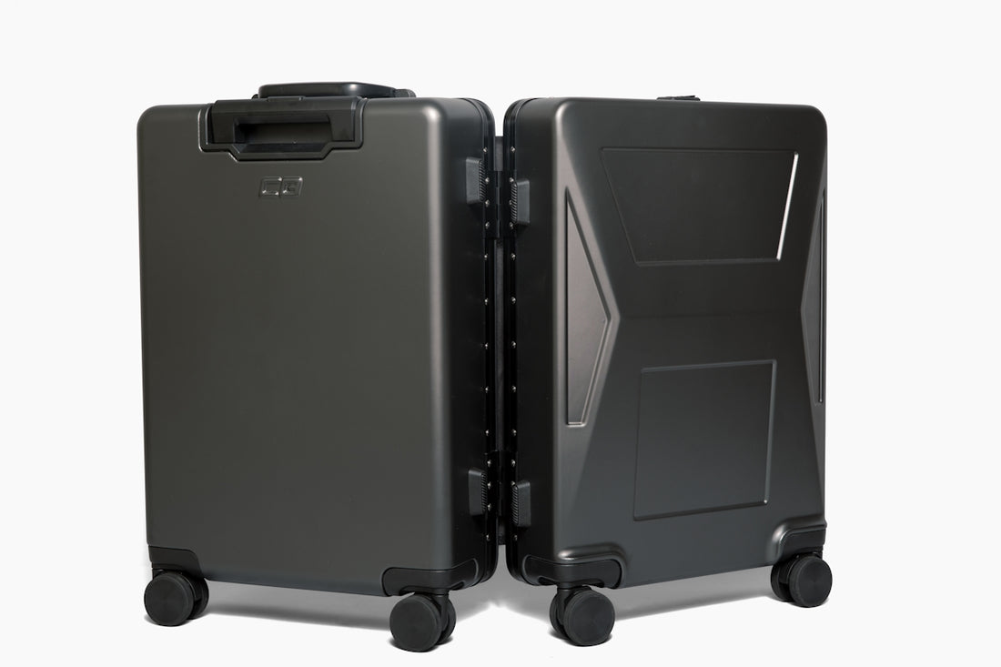 two black suitcases side by side on a white background
