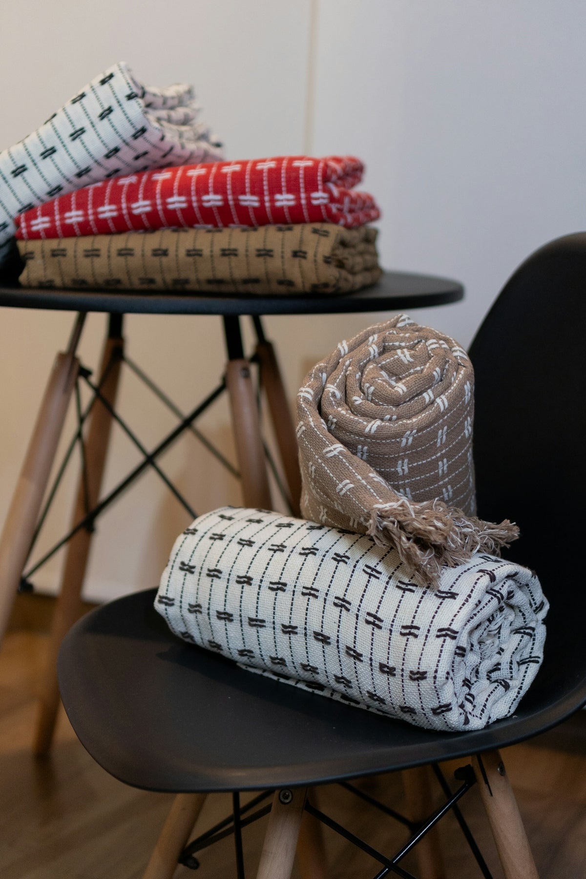 A stack of blankets sitting on top of a black chair