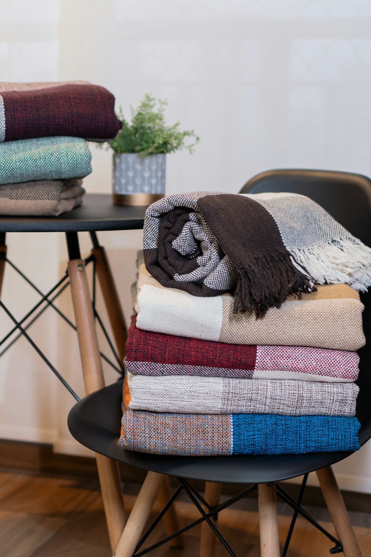 A stack of blankets sitting on top of a chair