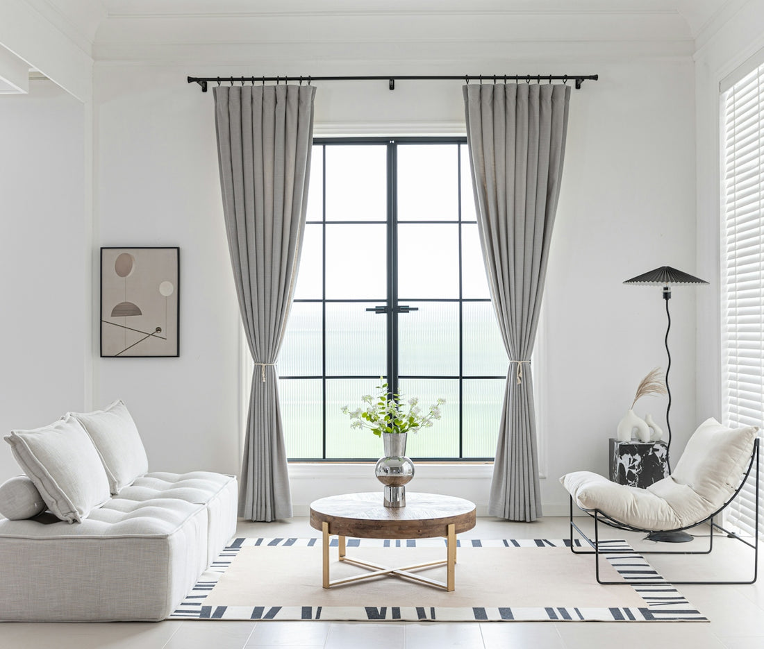 Modern living room with neutral color scheme and minimalist decor.