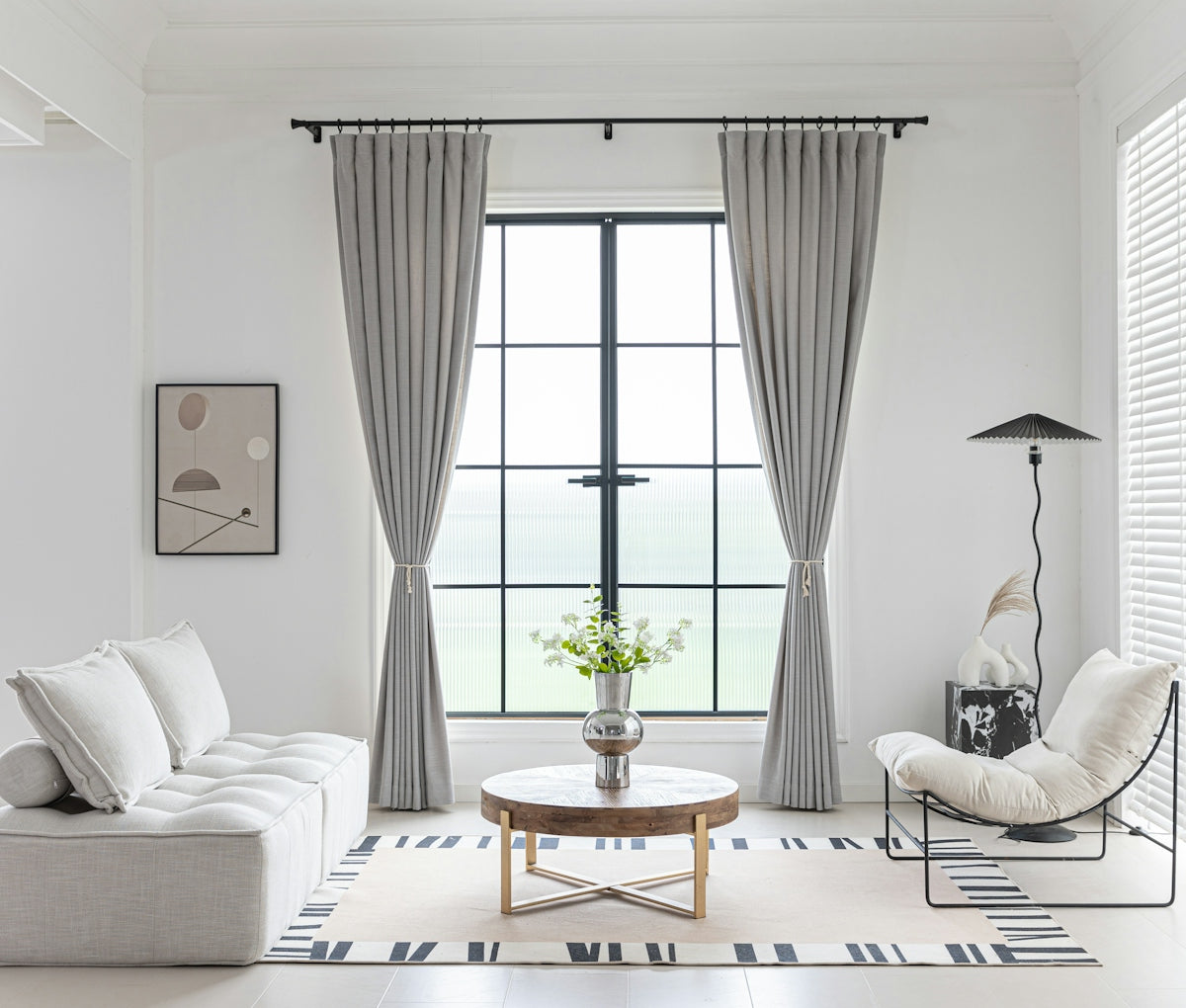 Modern living room with neutral color scheme and minimalist decor.