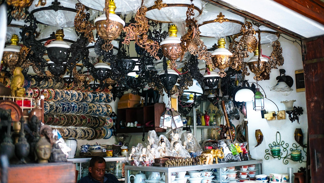 A cluttered shop filled with lamps and decorative items