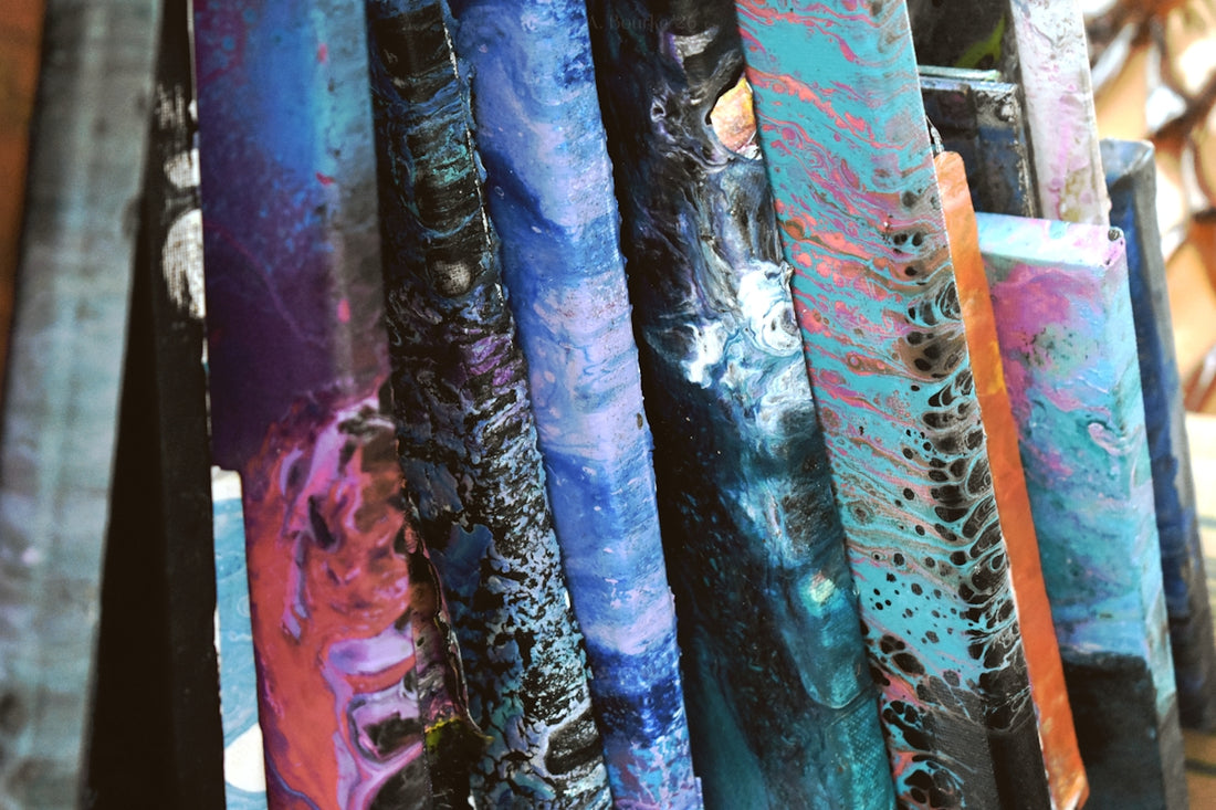 Abstract colorful fluid art canvases stacked vertically